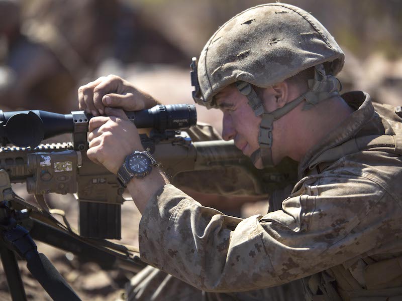 Sgt. Tyler J. Fox adjusts his M110 Semi-Automatic Sniper System's wind and elevation knobs in preparation of an unknown distance qualification range August 18 at Bradshaw Field Training Area, Northern Territory, Australia, during Exercise Koolendong 14. The range focused on increasing scout sniper's long range precision firing capabilities. The Marines challenged themselves with the M40 A5, M110 SASS and the M107 SASR. The Marines are with Scout Sniper Platoon, 1st Battalion, 5th Marine Regiment and are currently deployed in part of the Marine Rotational Force Darwin. The rotational deployment of U.S. Marines affords an unprecedented combined training opportunity with our Australian allies, and improves interoperability with our forces. Fox, a Winamac, Indiana native, is a scout sniper with the battalion and chief scout for the platoon. (Marine Corps Photo by Lance Cpl. Joey S. Holeman, Jr./ Released)